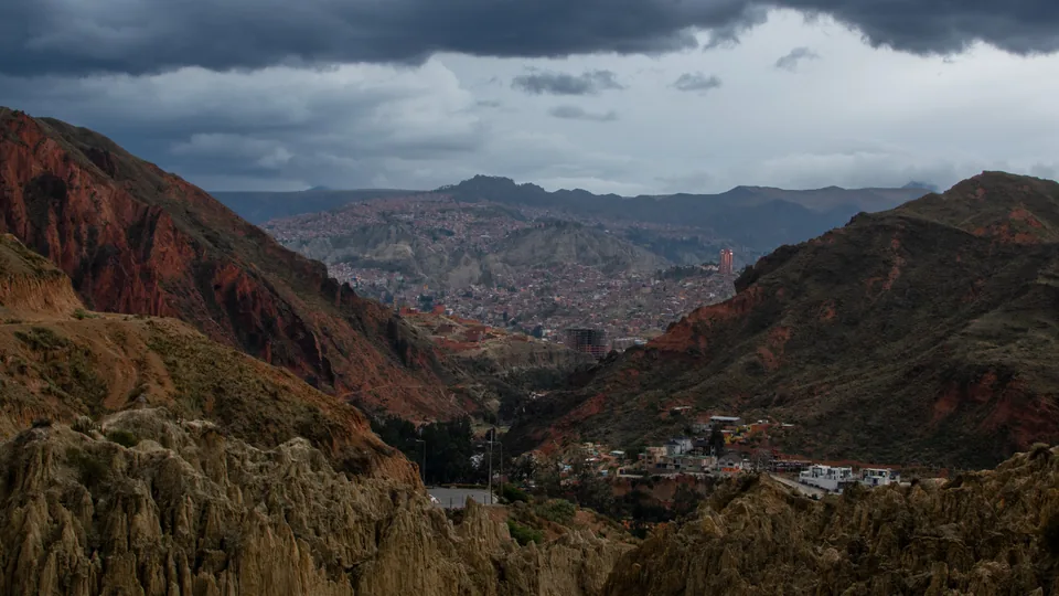 Mountain valley beneath dark storm clouds