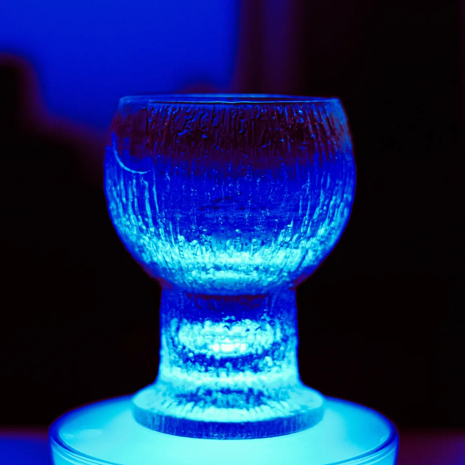 A textured glass illuminated in blue