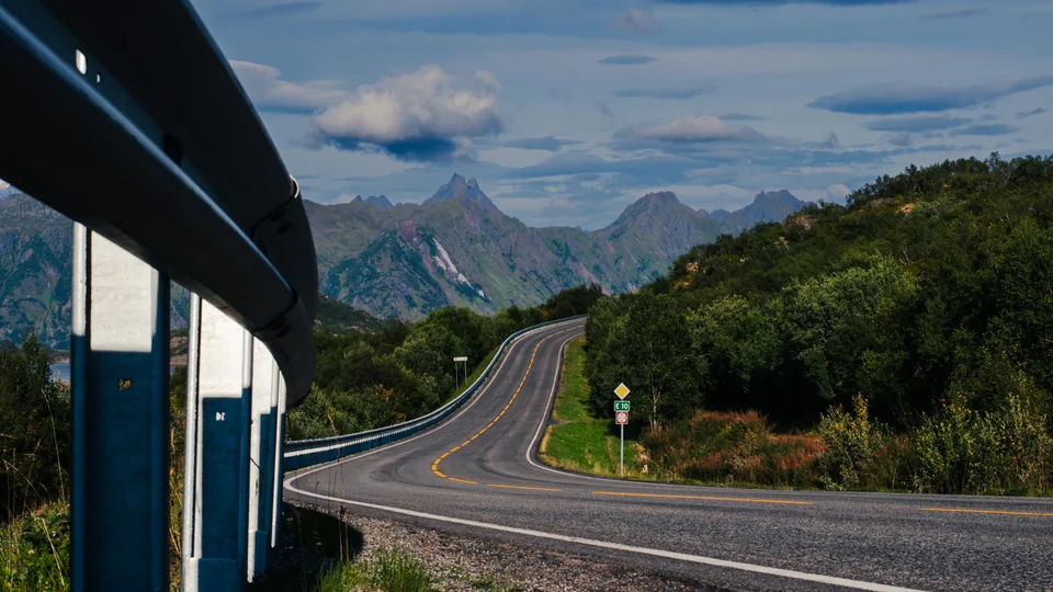 A mountain road seen beside a bus