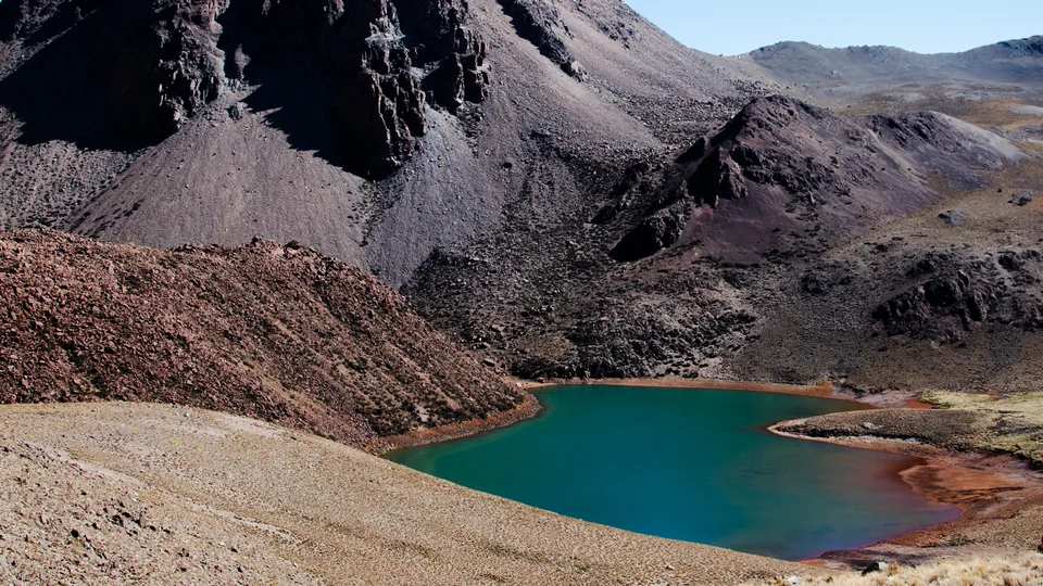 A turquoise lake surrounded by rocky mountains