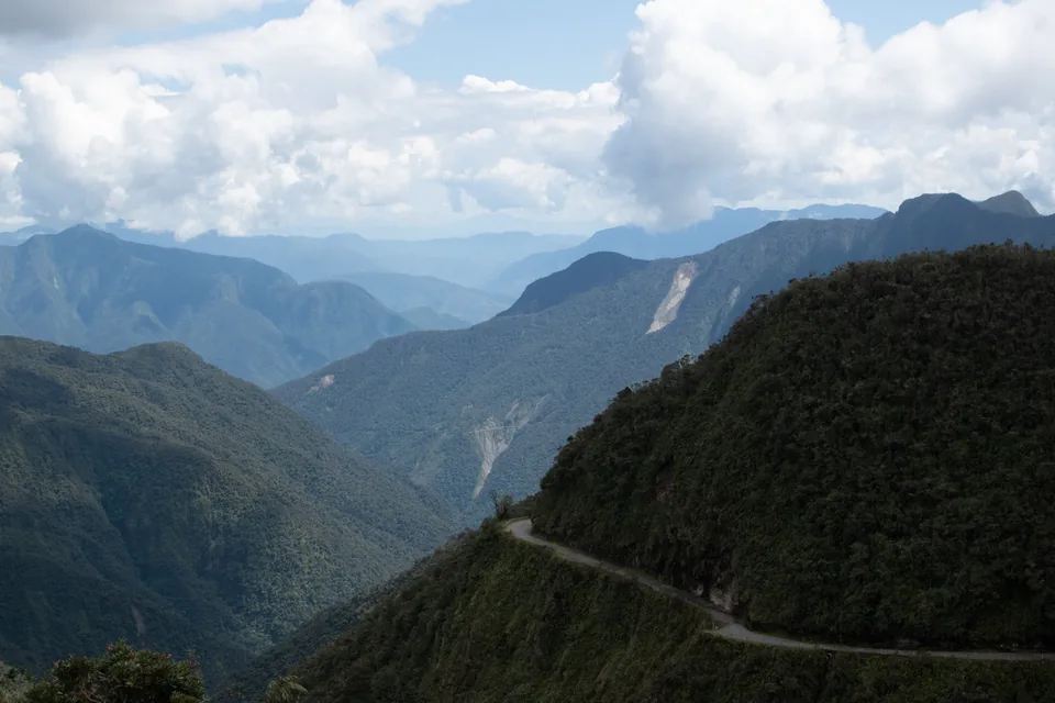 A winding road across a green mountain valley